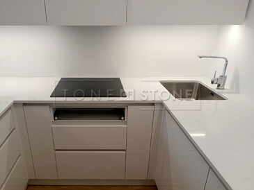 Pro moderní bílou kuchyni jsme se zákazníkem zvolili jako kuchyňskou desku umělý kámen Technistone Noble Supreme White. Zakázková výroba TONE OF STONE 