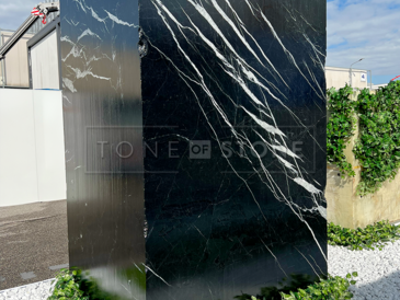 Blok španělského přírodního mramoru Nero Marquina na italském prodejním veletrhu.