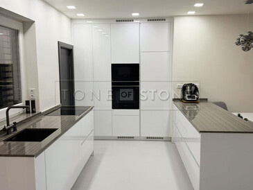 Bílá kuchyně s kamennou pracovní deskou z šedé žuly Grey Veneer