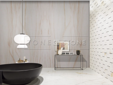 Kvarcit SKY GOLD - velkoformátový přírodní kámen, země původu Brazílie. Velmi oblíben pro svůj výjimečný elegantní vzhled, kterému dominuje béžová barva s decentními šedými a hnědými tony. Jeho použití je velmi univerzální. Pro svou odolnost je vhodný pro výrobu parapetů, koupelnových a kuchyňských desek, výrobu obkladů a dlažeb, obklady krbů a krbových říms, obložení saun nebo pro výrobu designových stolů. Skladem v kamenictví TONE OF STONE.