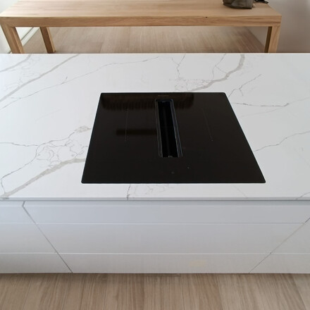 Varn&aacute; deska zapu&scaron;těn&aacute; do roviny s integrovan&yacute;m odsavačem jako souč&aacute;st pracovn&iacute; desky z materi&aacute;lu Crystal Calacatta Silva. Zak&aacute;zkov&aacute; v&yacute;roba TONE OF STONE.