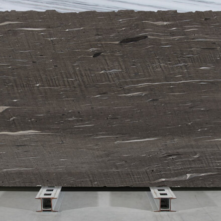 Hnědá kamenná deska Brown Silk s vodorovným žilkováním v šedých a bílých tónech.