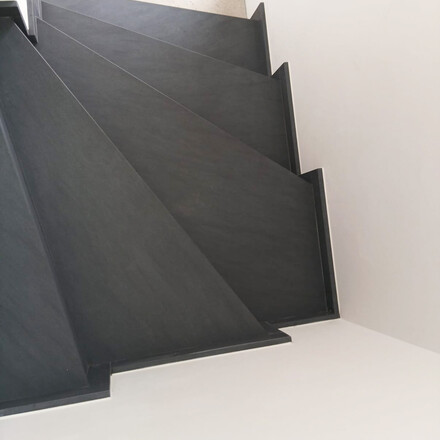 Vnitřn&iacute; schodi&scaron;tě z př&iacute;rodn&iacute;ho kamene Carbon Grey s bočn&iacute;mi sokly